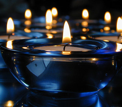 Several tealight candles light the darkness.