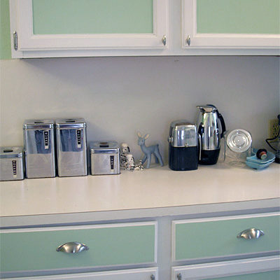 Kitchen with light green cabinets.