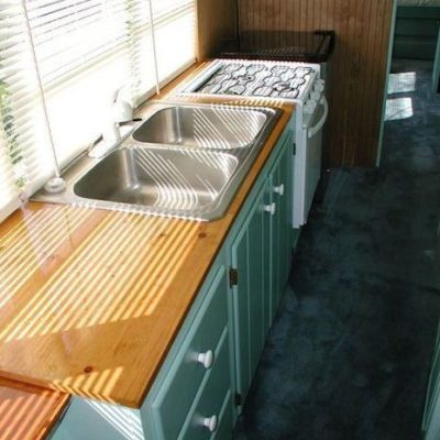 A wooden countertop with metal sink.