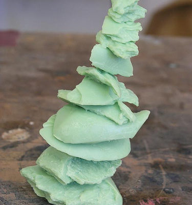 A tower of soap bars, made in an emerald green color.