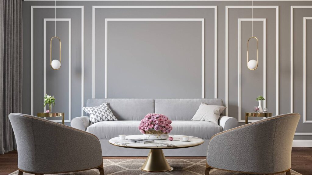 Gray with white trim wainscoting behind gray couch and gold accent table