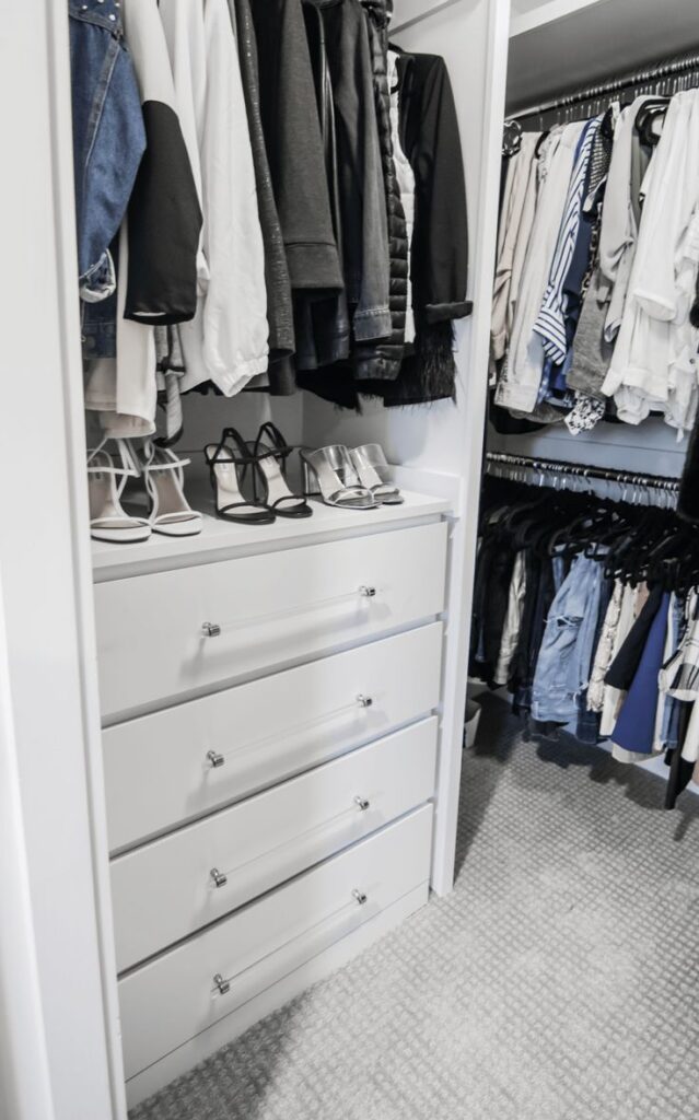 IKEA Malm dresser in white closet with pairs of shoes stacked on top