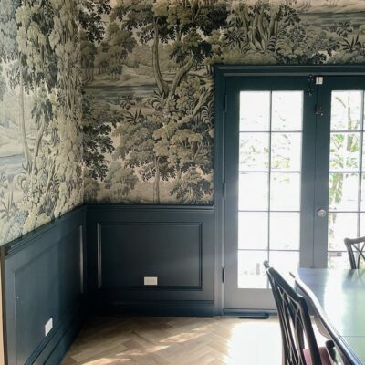 Dining room with green wainscoting and green floral wallpaper