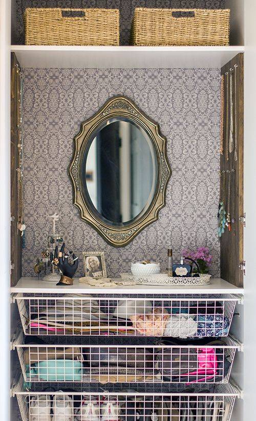 Vanity inside of IKEA shelf with gold mirror and hanging hooks