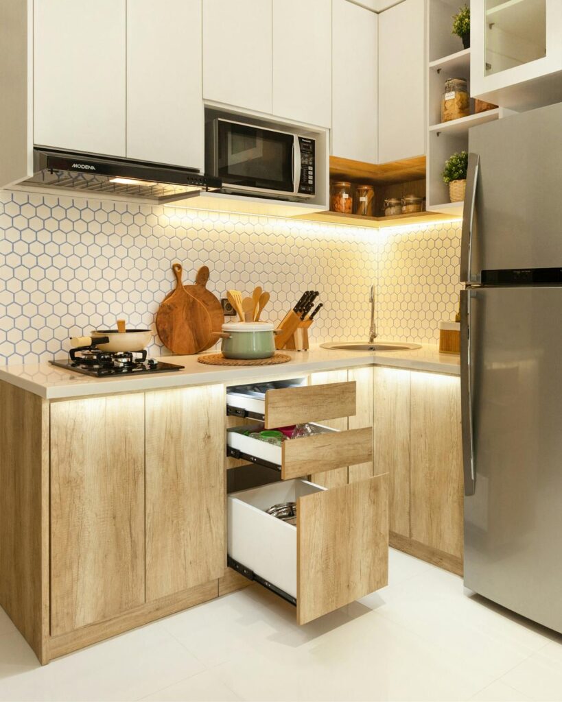 Stylish Scandinavian kitchen with wood cabinets and stainless-steel appliances.