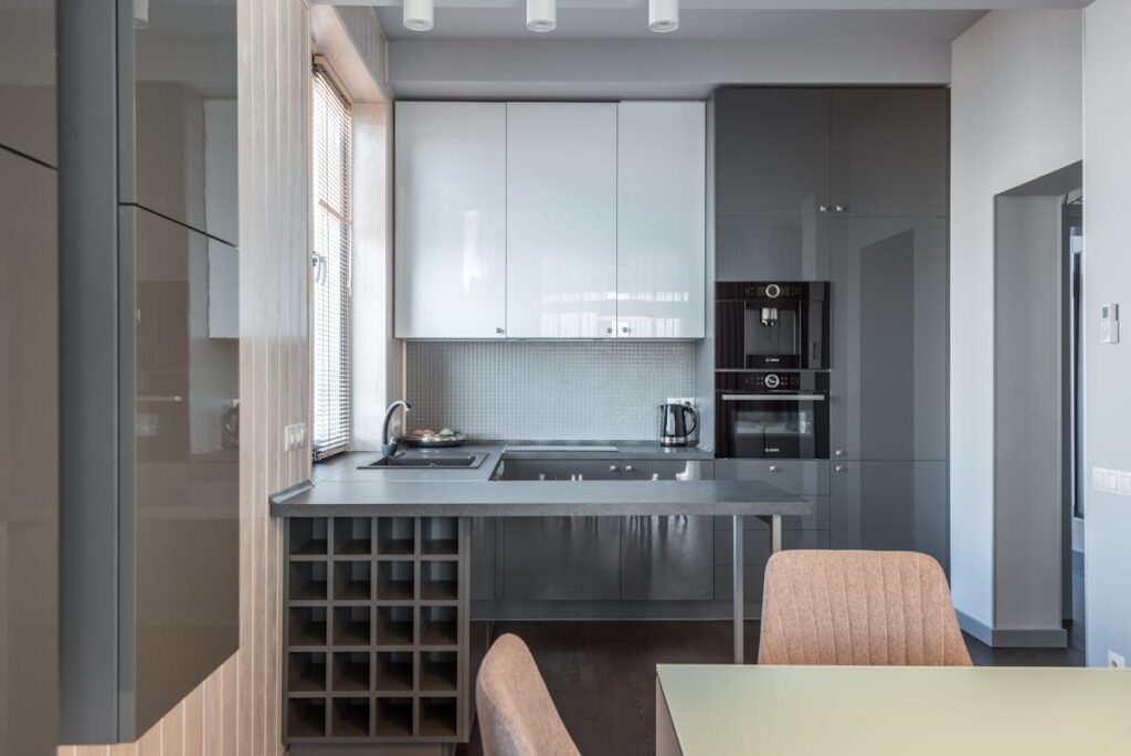 Sleek modern kitchen with neutral tones and minimalist design featuring appliances.