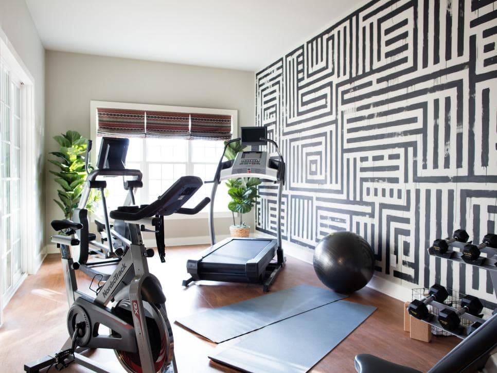 Home gym space with large geometric black and white mural